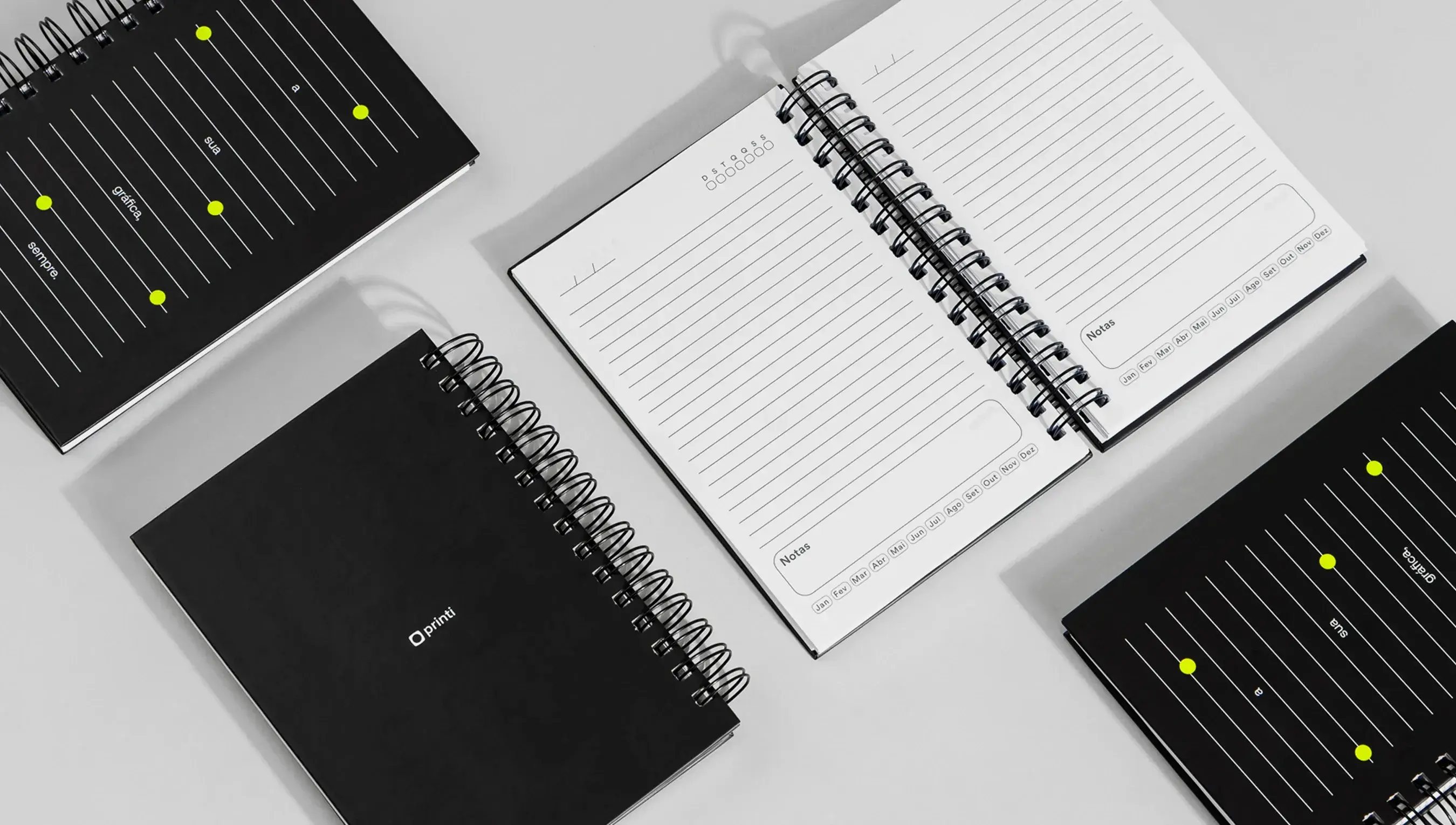 Agendas personalizadas com capa preta e miolo pautado, encadernadas com espiral, da Printi, ideal para kit onboarding